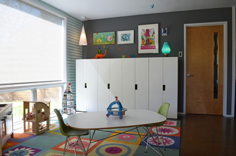 Design ideas for a midcentury gender-neutral kids' playroom for kids 4-10 years old in Dallas with grey walls.