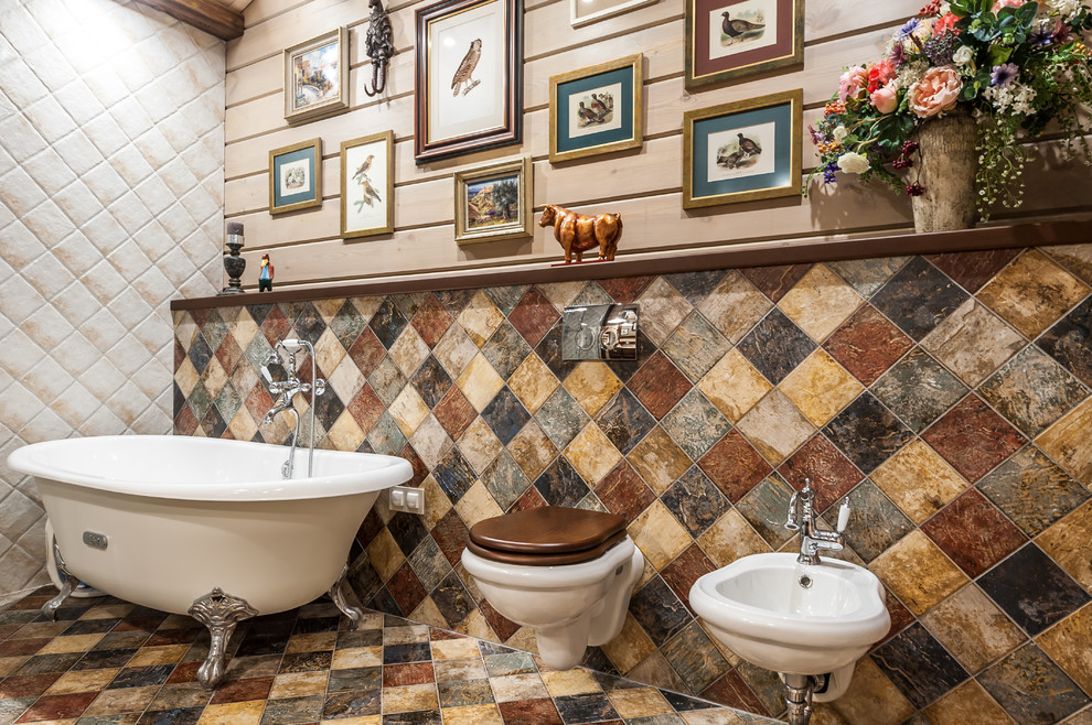 Photo of a mid-sized country master wet room bathroom in Other with a claw-foot tub, a bidet, beige walls, multi-coloured floor, multi-coloured tile, cement tile, ceramic floors, an integrated sink, a hinged shower door, flat-panel cabinets, dark wood cabinets, solid surface benchtops, beige benchtops, a single vanity, a freestanding vanity, exposed beam and wood walls.