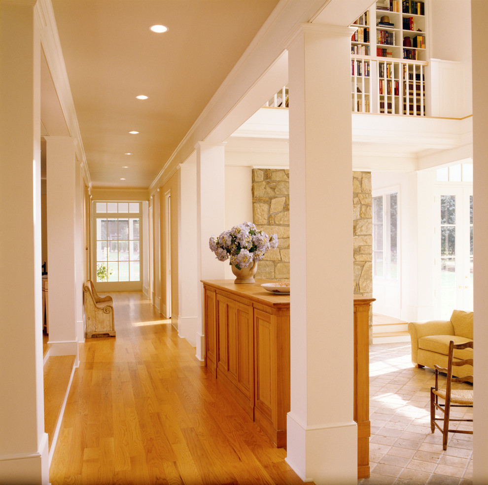 Traditional hallway in DC Metro with white walls and light hardwood floors.