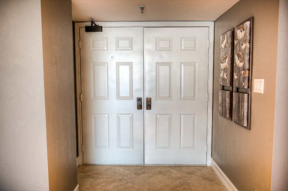 Design ideas for a mid-sized midcentury front door with beige walls, a double front door, a white front door and beige floor.
