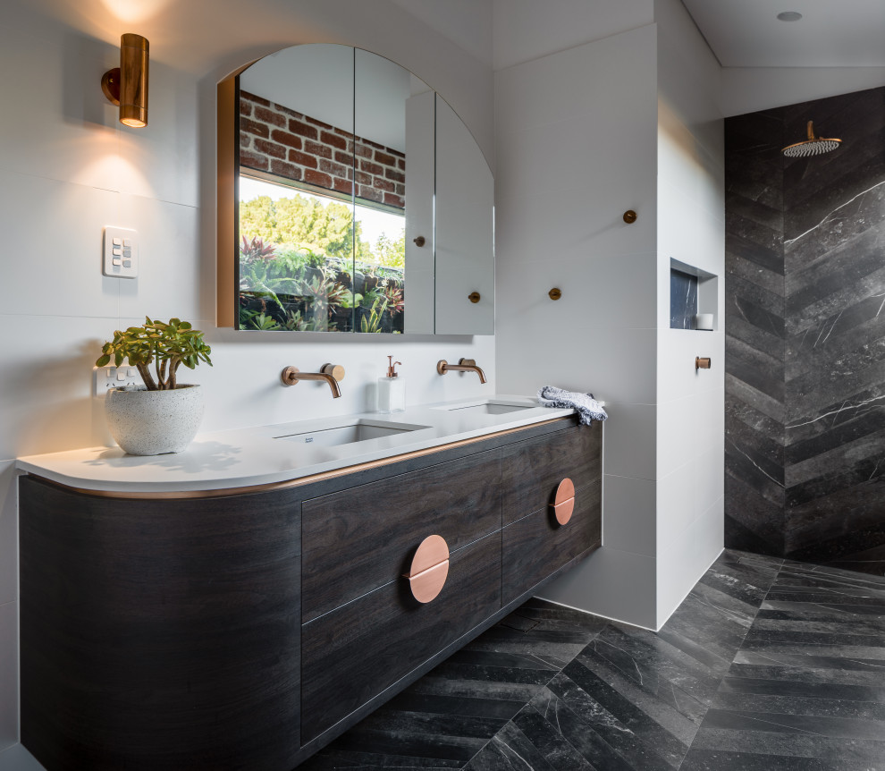 This is an example of an industrial bathroom in Perth with engineered quartz benchtops, white benchtops, flat-panel cabinets, dark wood cabinets, a curbless shower, white walls, an undermount sink, black floor, an open shower, a double vanity, a floating vanity and vaulted.
