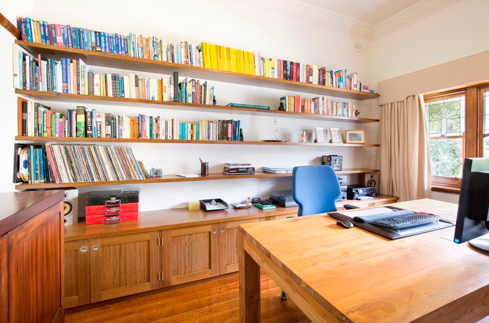 This is an example of a large contemporary study room in Melbourne with white walls, medium hardwood floors, no fireplace and a freestanding desk.