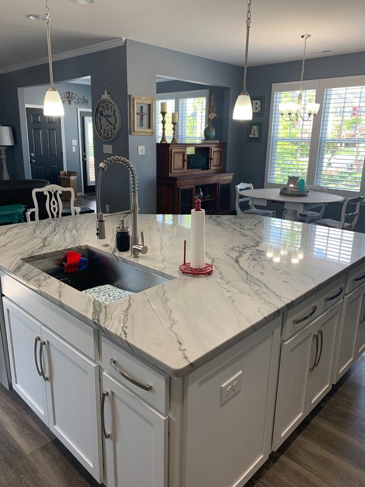 This is an example of a large transitional eat-in kitchen in Richmond with an undermount sink, quartzite benchtops, stainless steel appliances, with island and white benchtop.