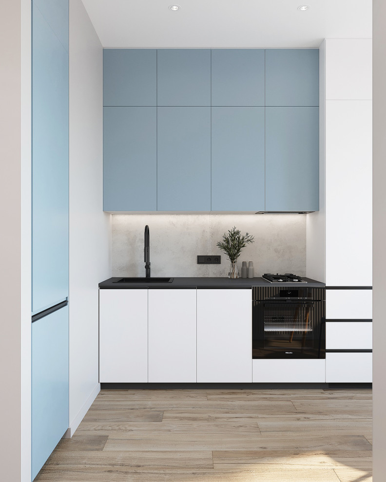 Photo of a small contemporary single-wall eat-in kitchen in Other with an undermount sink, flat-panel cabinets, blue cabinets, quartz benchtops, grey splashback, porcelain splashback, black appliances, porcelain floors, beige floor and black benchtop.