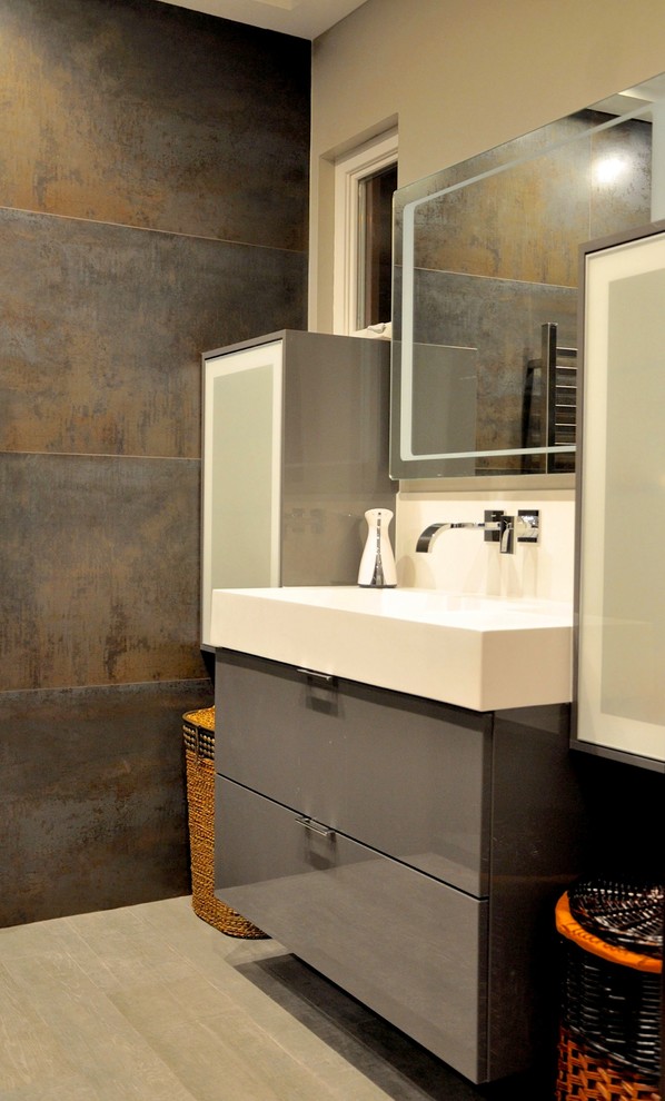 This is an example of a modern bathroom in San Francisco with glass-front cabinets and porcelain floors.