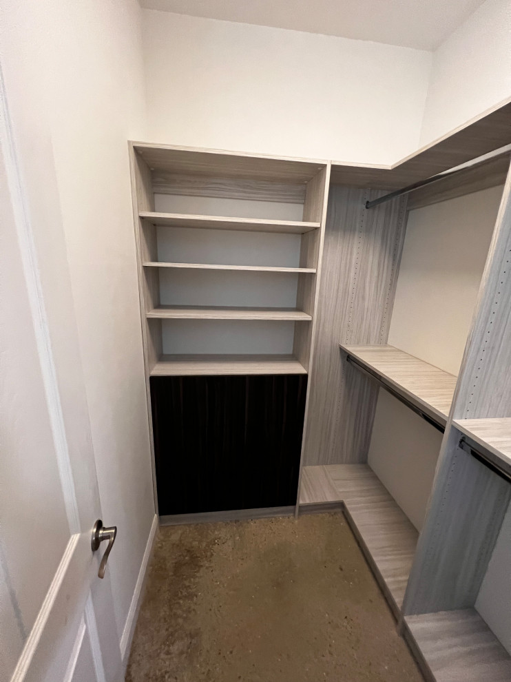 Photo of a small contemporary men's walk-in wardrobe in Tampa with flat-panel cabinets and concrete floors.