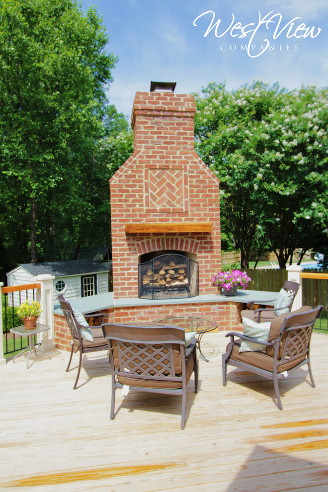 Large traditional backyard deck in Richmond with a fire feature and no cover.
