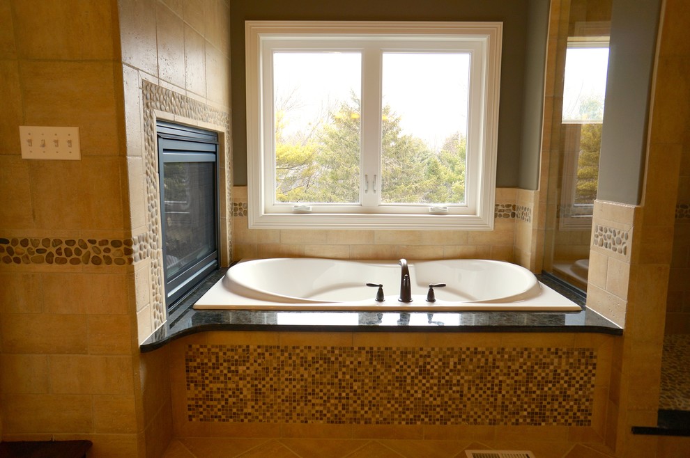 Large country bathroom in Chicago with a pedestal sink, dark wood cabinets, granite benchtops, a hot tub, a one-piece toilet, beige tile, ceramic tile, grey walls, ceramic floors and with a sauna.