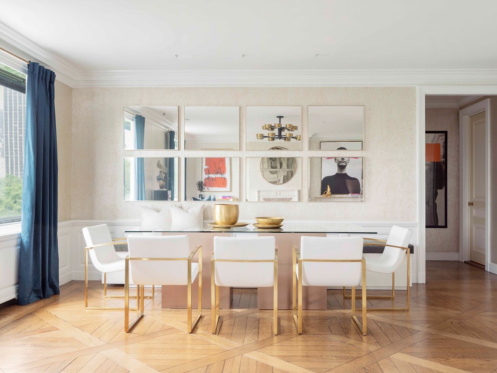This is an example of a contemporary dining room in New York with beige walls, medium hardwood floors and brown floor.