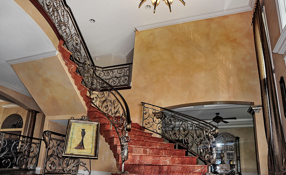 Traditional acrylic curved staircase in Phoenix with concrete risers.