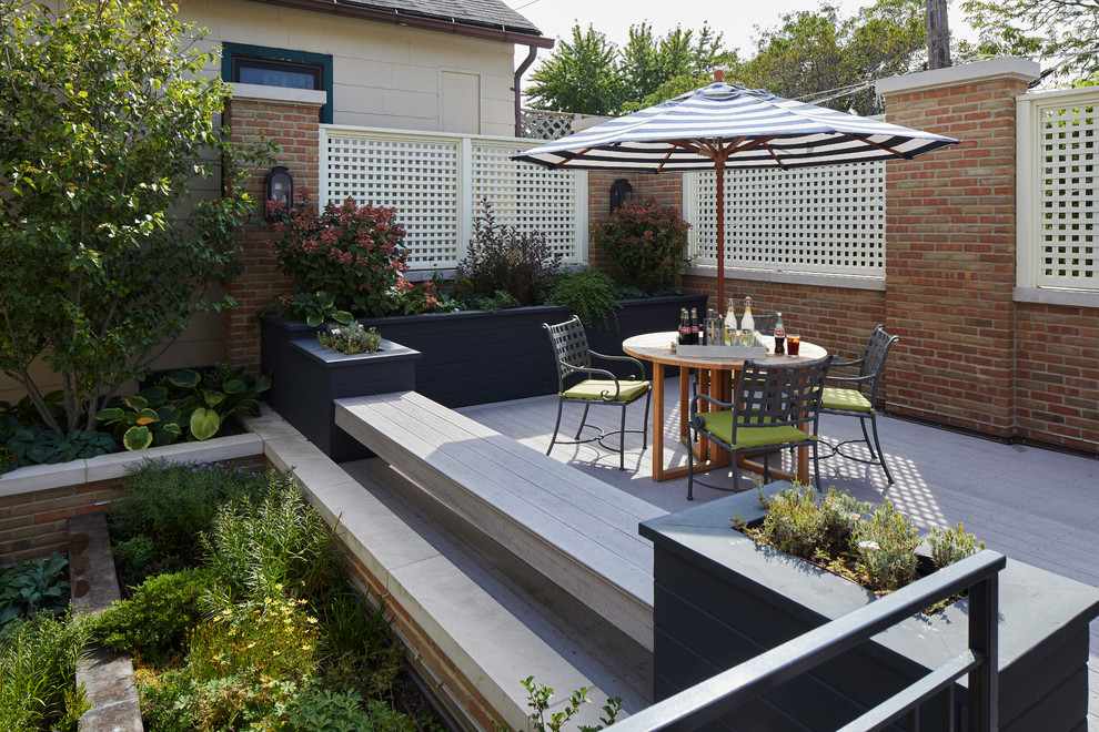 Mid-sized transitional backyard patio in Chicago with a container garden, decking and no cover.