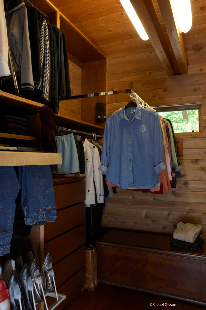 This is an example of a mid-sized transitional gender-neutral walk-in wardrobe in Seattle with flat-panel cabinets, medium wood cabinets, dark hardwood floors and exposed beam.