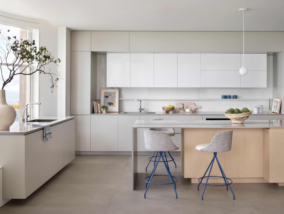 Inspiration for a mid-sized modern galley separate kitchen in Denver with an undermount sink, flat-panel cabinets, quartz benchtops, stainless steel appliances, with island, grey floor, grey benchtop, white cabinets, white splashback and ceramic splashback.