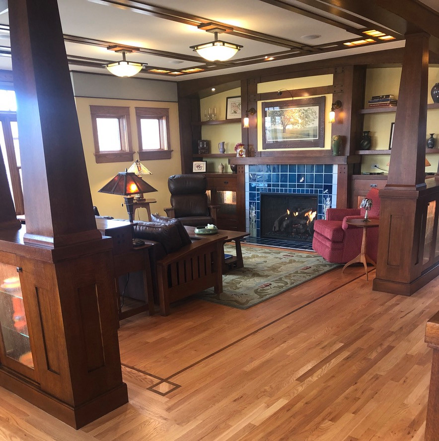 Mid-sized arts and crafts enclosed living room in Denver with yellow walls, medium hardwood floors, a standard fireplace and a tile fireplace surround.