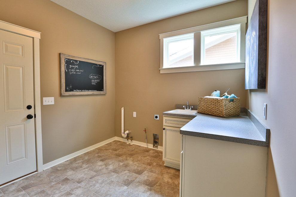 Design ideas for a mid-sized l-shaped utility room in Minneapolis with recessed-panel cabinets, white cabinets, laminate benchtops, beige walls and vinyl floors.