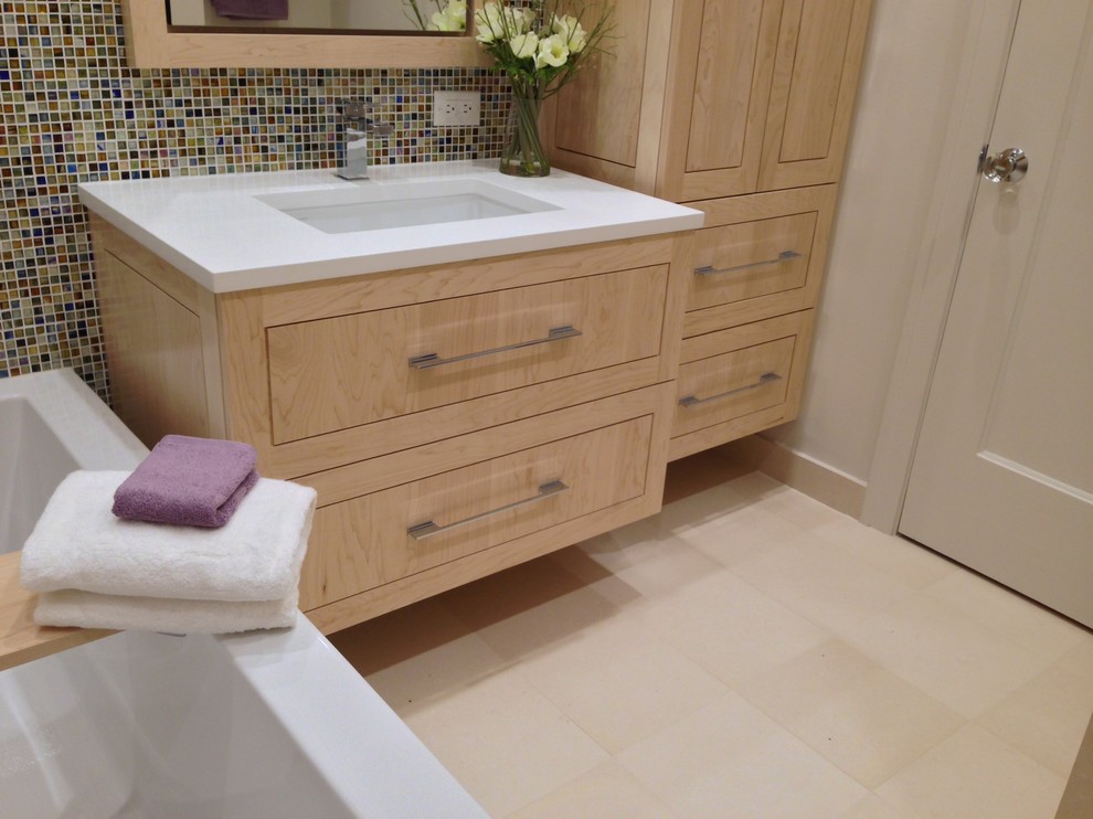 Mid-sized transitional master multicolored tile and mosaic tile marble floor freestanding bathtub photo in Chicago with an undermount sink, furniture-like cabinets, light wood cabinets, quartz countertops, a one-piece toilet and beige walls