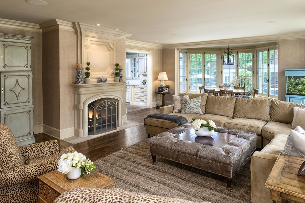 Inspiration for a large traditional open concept family room in New York with beige walls, dark hardwood floors, a standard fireplace, a concrete fireplace surround and brown floor.