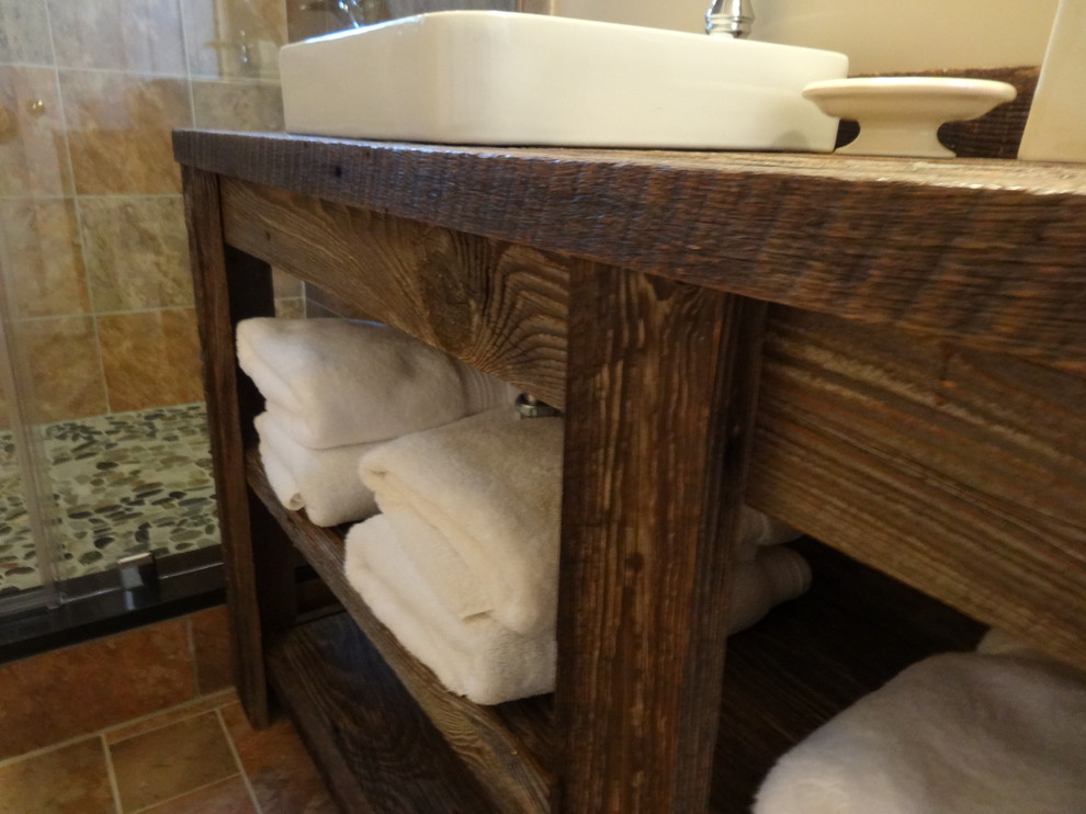 Mid-sized mountain style master beige tile and ceramic tile ceramic tile corner bathtub photo in Charlotte with a drop-in sink, furniture-like cabinets, dark wood cabinets, wood countertops, a two-piece toilet and beige walls