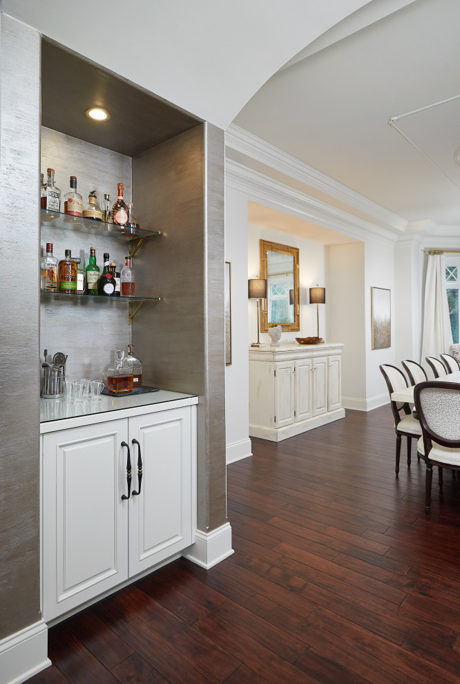 Design ideas for a mediterranean home bar in Grand Rapids with white cabinets, glass worktops and brown splashback.