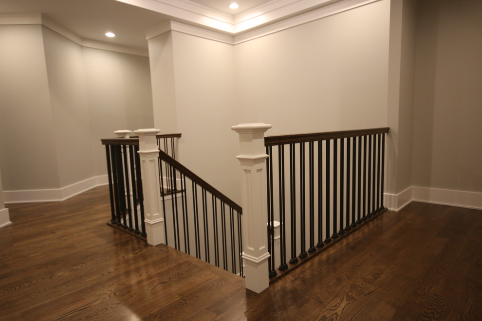 Inspiration for a large industrial wood u-shaped staircase in Chicago with painted wood risers and metal railing.