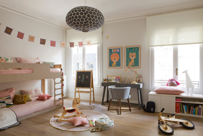 Inspiration for a large kids' bedroom for kids 4-10 years old and girls in Barcelona with white walls, medium hardwood floors and brown floor.