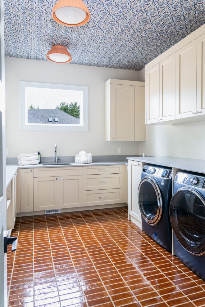 Design ideas for a mid-sized modern laundry room in Portland with brick floors and brown floor.