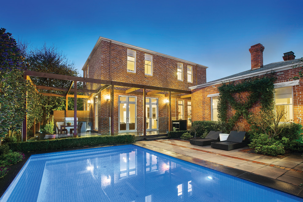 Large contemporary rectangular pool in Melbourne with concrete pavers.