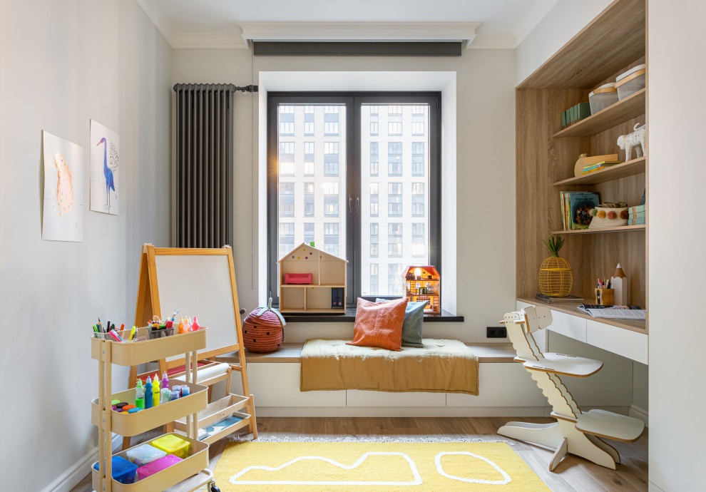This is an example of a medium sized contemporary children’s room for girls in Moscow with white walls, medium hardwood flooring, beige floors and feature lighting.