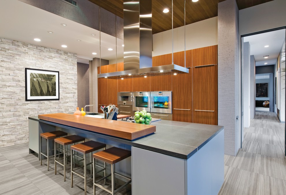 Photo of a contemporary kitchen in Philadelphia with a single-bowl sink, flat-panel cabinets, medium wood cabinets, with island and grey floor.