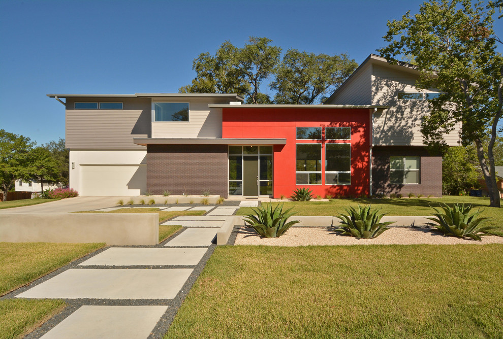 Design ideas for a contemporary two-storey exterior in Austin with mixed siding.