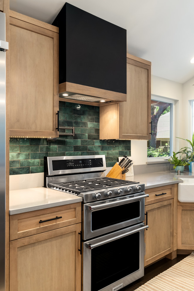 Urban u-shaped dark wood floor eat-in kitchen photo in Seattle with a farmhouse sink, light wood cabinets, quartzite countertops, green backsplash, stainless steel appliances, no island and gray countertops