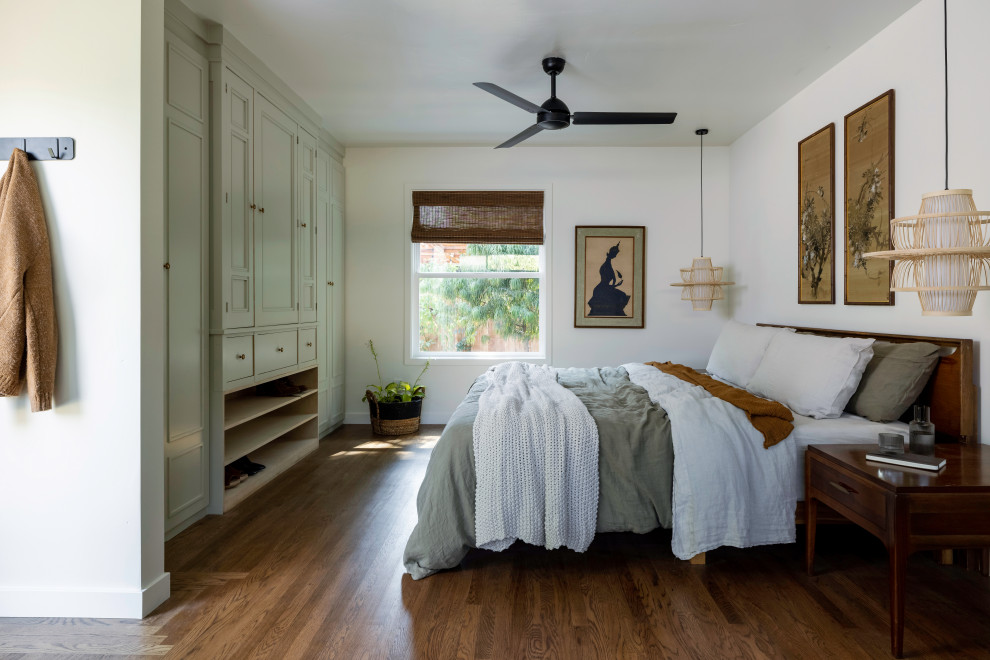 Design ideas for a large transitional master bedroom in Sacramento with white walls, medium hardwood floors and brown floor.