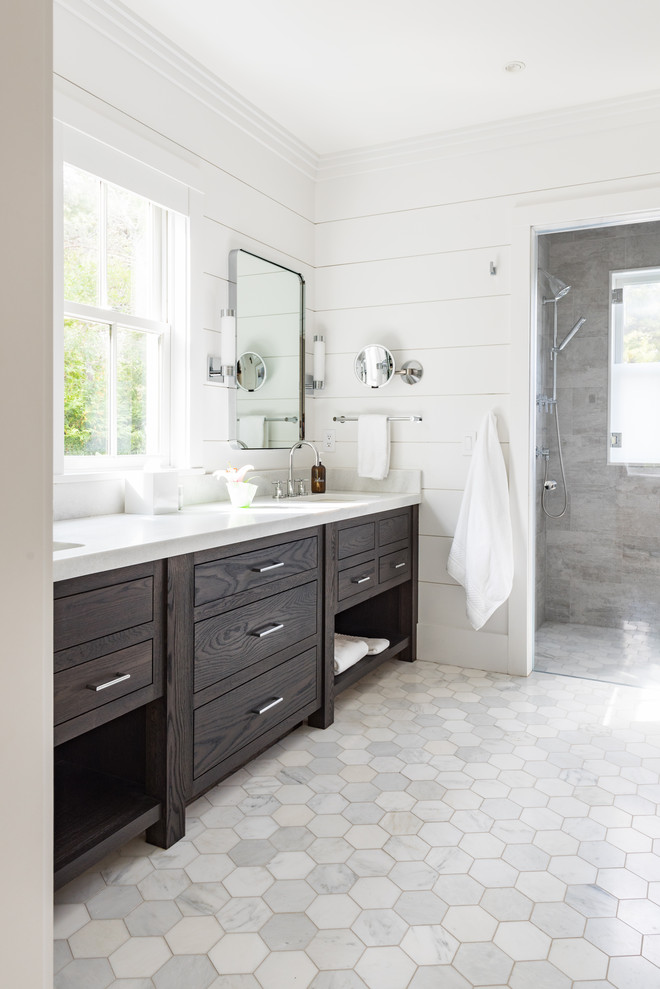 Alcove shower - transitional master marble floor and gray floor alcove shower idea with flat-panel cabinets, dark wood cabinets, white walls, an undermount sink, quartz countertops, a hinged shower door and gray countertops