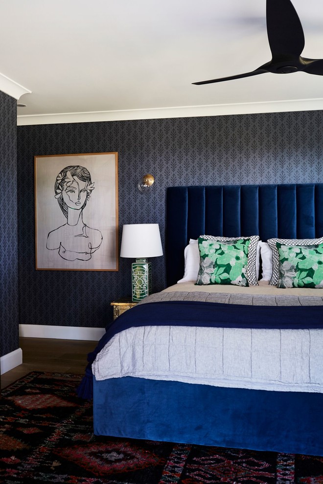 Photo of a bedroom in Other with blue walls and dark hardwood floors.