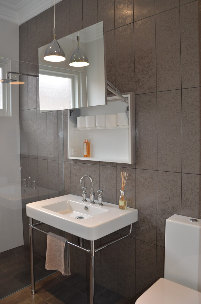 Contemporary bathroom in Other with gray tile and glass-front cabinets.