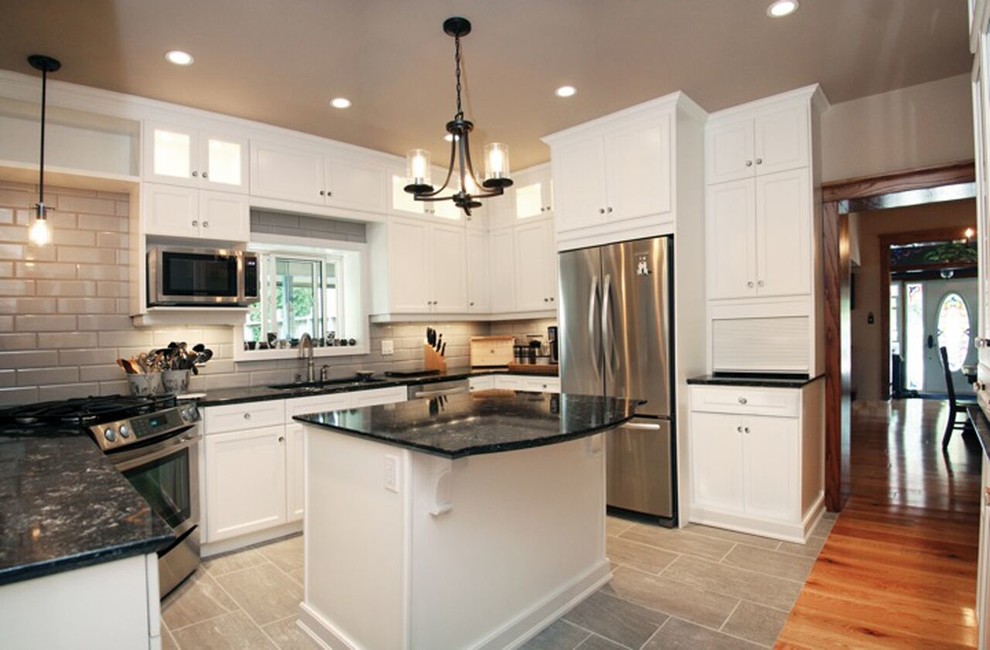 Eat-in kitchen - mid-sized transitional u-shaped porcelain tile eat-in kitchen idea with a double-bowl sink, shaker cabinets, white cabinets, granite countertops, gray backsplash, glass tile backsplash, stainless steel appliances and an island