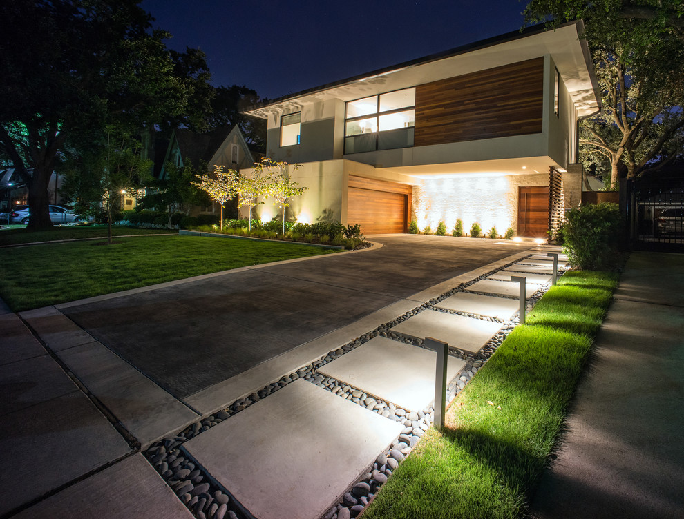 Design ideas for a modern front yard full sun driveway for summer in Dallas with a garden path.