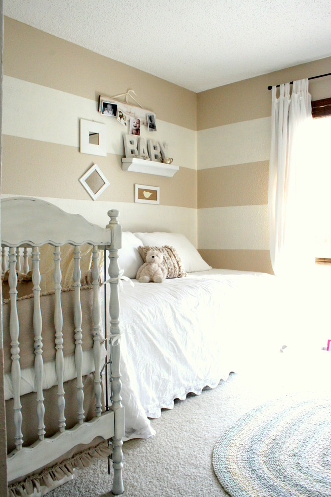 This is an example of a traditional gender-neutral nursery in Dallas with beige walls and carpet.