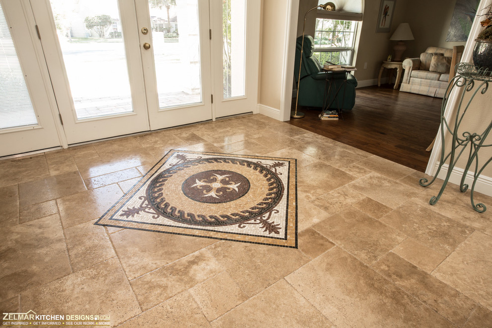 Inspiration for a large timeless travertine floor foyer remodel in Orlando with beige walls