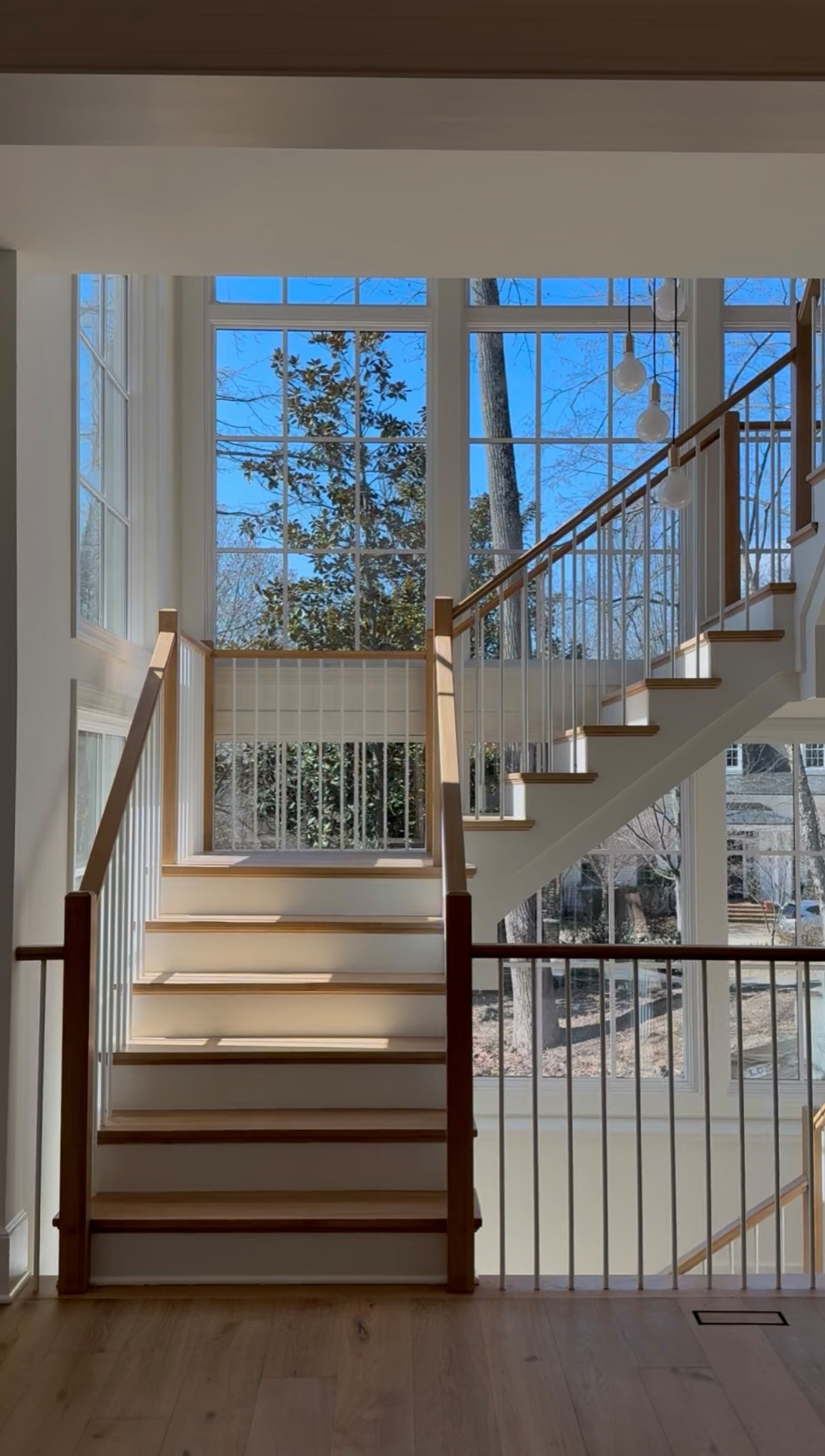 Project #152 | Three-Story White Oak Staircase with a Pendant Chandelier