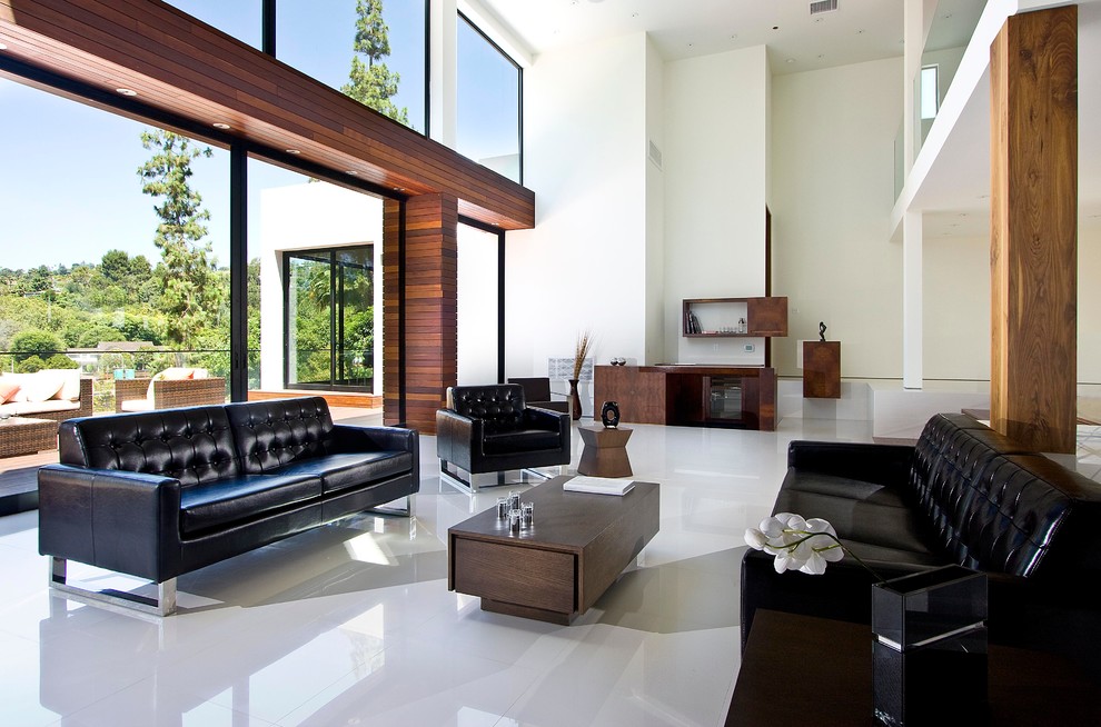 Large contemporary open concept living room in Los Angeles with white walls and marble floors.