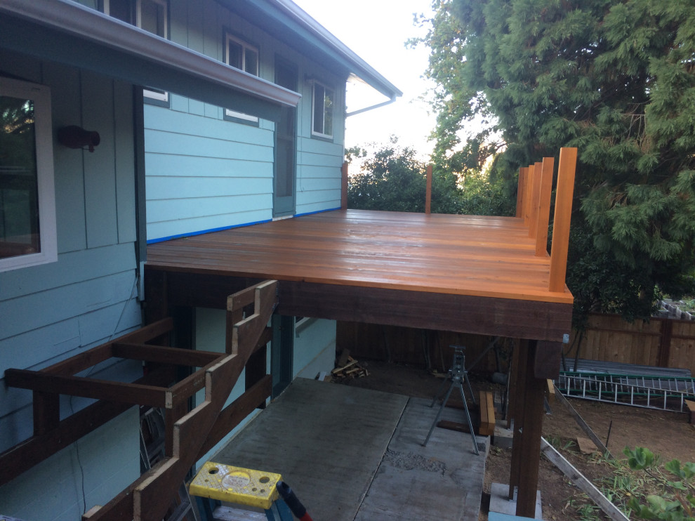 Deck - small backyard second story wood railing deck idea with no cover