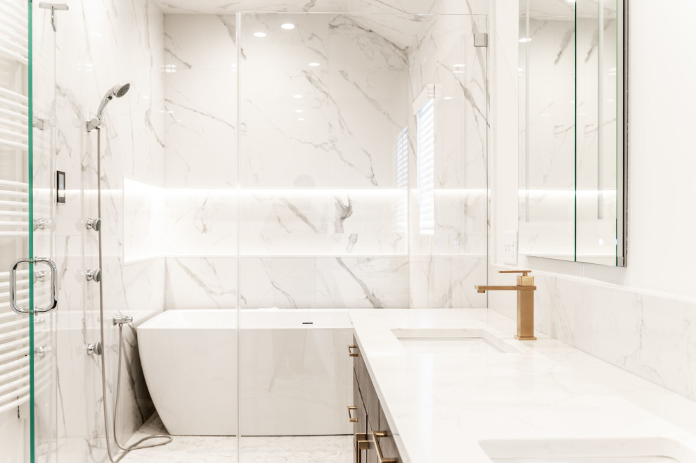 Inspiration for a transitional master bathroom in New York with white cabinets, a freestanding tub, an open shower, white tile, marble, white walls, a drop-in sink, marble benchtops, white floor, a hinged shower door, white benchtops and a double vanity.