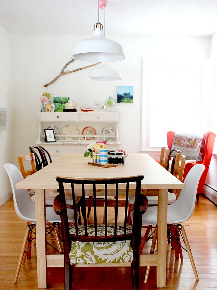Eclectic dining room in Burlington with white walls and light hardwood floors.