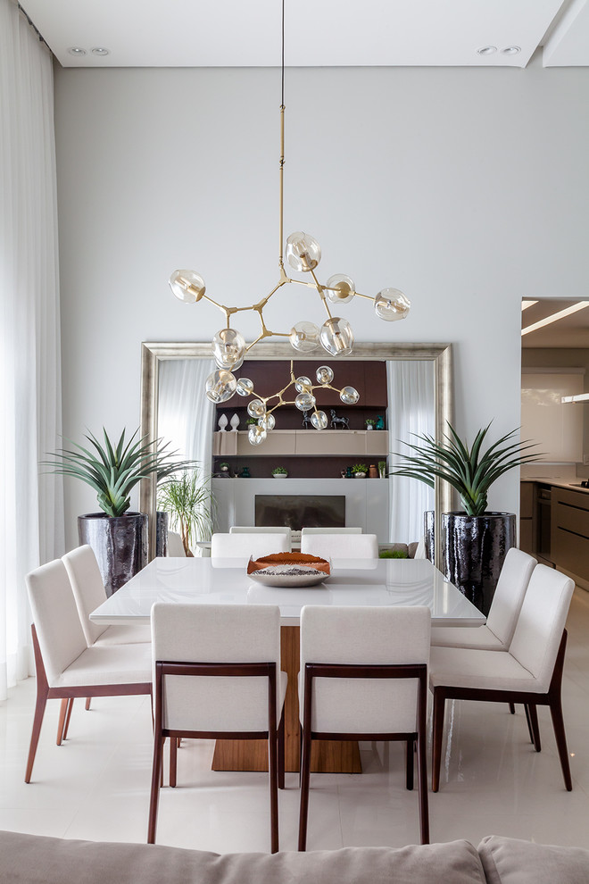 This is an example of a contemporary dining room in Other with white walls and white floor.