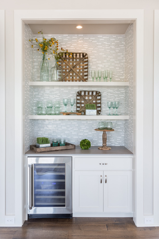 Small country single-wall wet bar in Austin with shaker cabinets, white cabinets, green splashback, matchstick tile splashback, medium hardwood floors, brown floor and grey benchtop.
