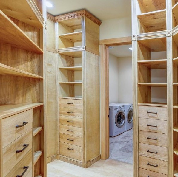 Inspiration for a large traditional gender-neutral walk-in wardrobe in Tampa with light wood cabinets, laminate floors and multi-coloured floor.
