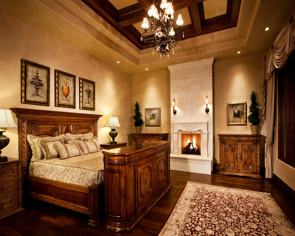 Mid-sized traditional master bedroom in Phoenix with beige walls, medium hardwood floors, a standard fireplace and a stone fireplace surround.