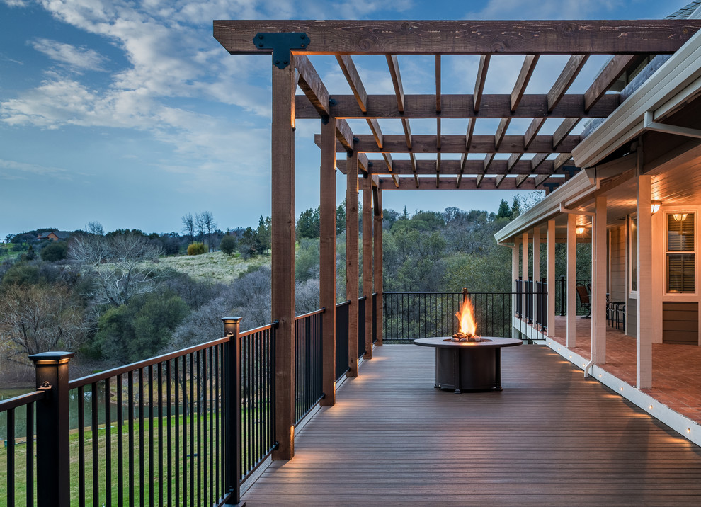 Design ideas for a large country backyard deck in Sacramento with a pergola.