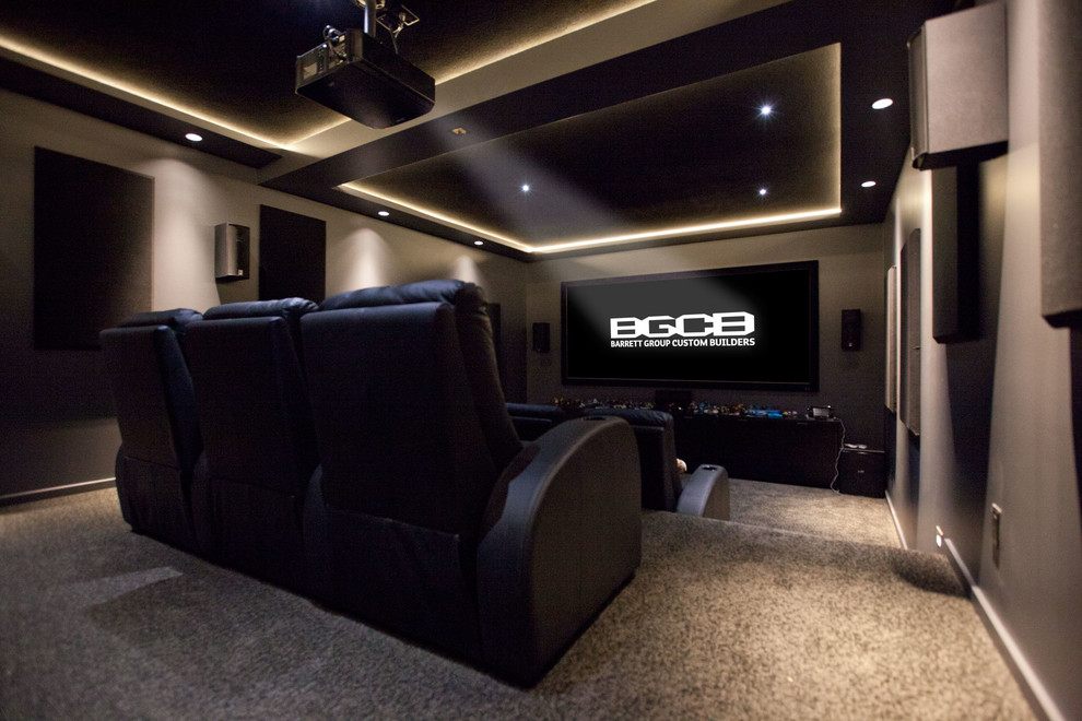 Photo of a large modern enclosed home theatre in Vancouver with grey walls, carpet and a projector screen.
